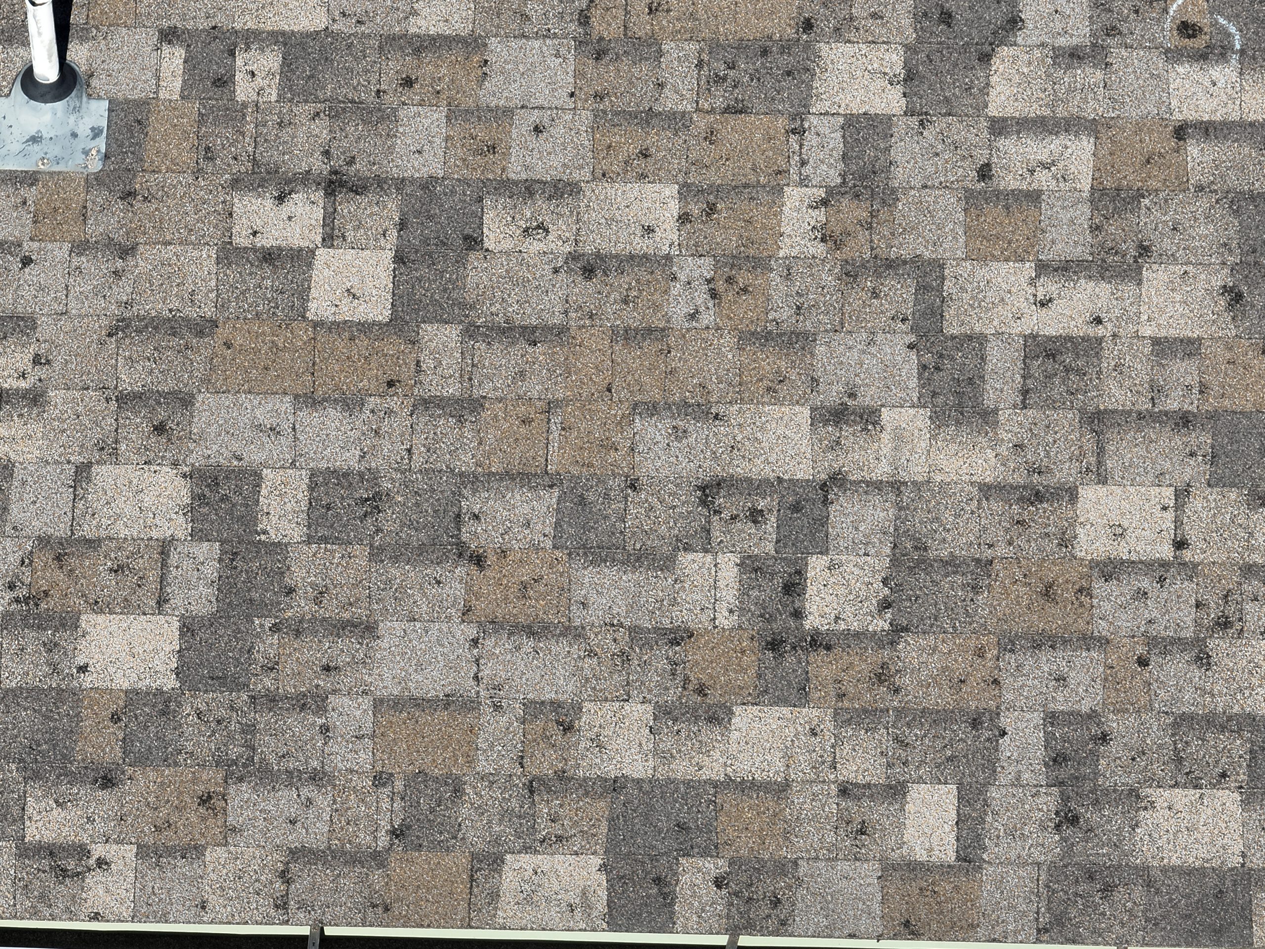 Hail Damage on Standard Asphalt Shingles Central Iowa - Superstorm Roofing & Siding Close-up hail damage on standard asphalt shingles showing impact marks — reason to upgrade to Class 4 in Des Moines Iowa