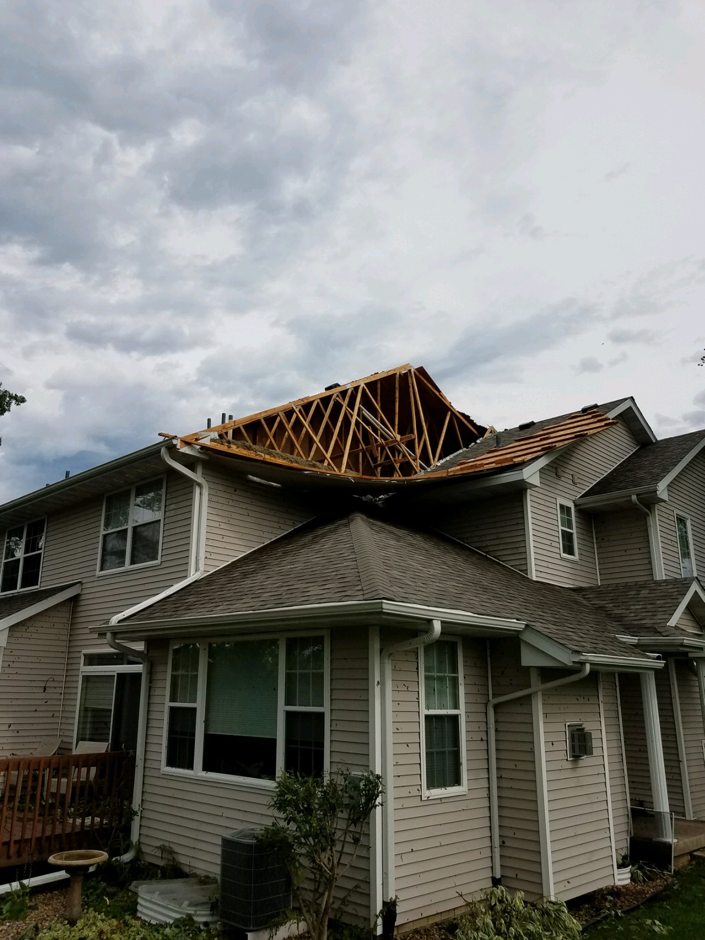 Severe wind damage exposing roof trusses on Central Iowa home
