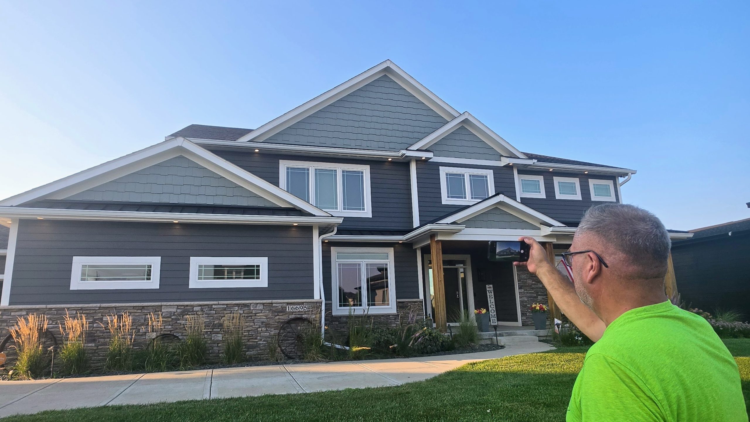 Superstorm owner Chandler Steffy taking a photo of a home for the AI roof visualizer
