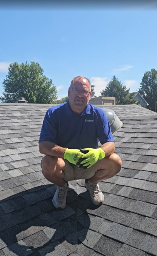 Superstorm Roofing owner Chandler Steffy reviewing roof inspection findings with Des Moines homeowner